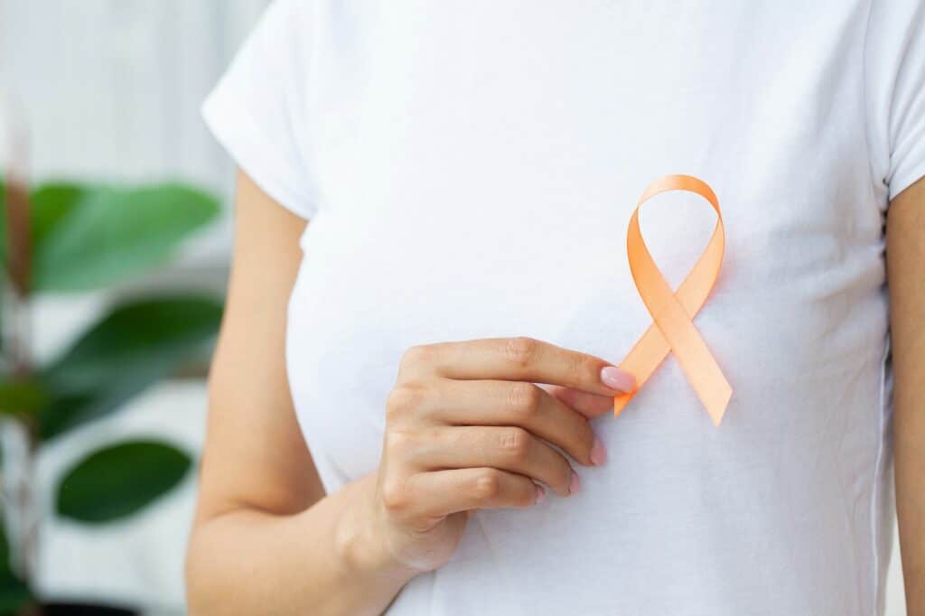 Doctor holding orange ribbon Leukemia cancer awareness and Multiple sclerosis