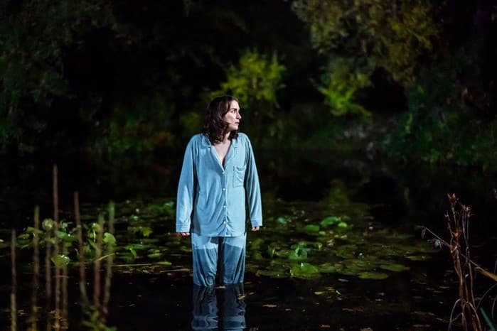 Emma standing in a pond at night in her pyjamas