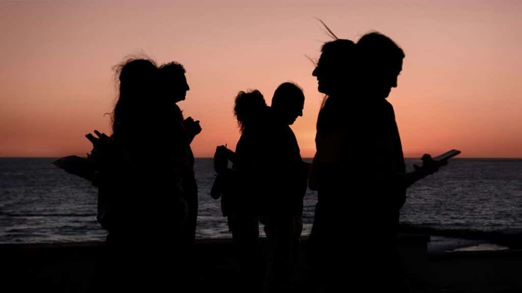 Six people are shown in silhouette
